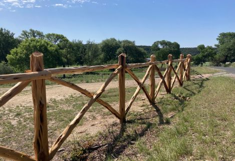 This type of cross-rail fence is common in the area around Hunt, Texas, where we installed this one.