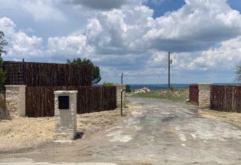 This is a low-fence entrance we built using limestone columns and 5' cedar staves