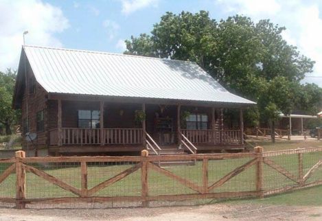 This custom cedar fence was built using hand-hewn cedar posts, milled cedar lumber, and cattle panel.