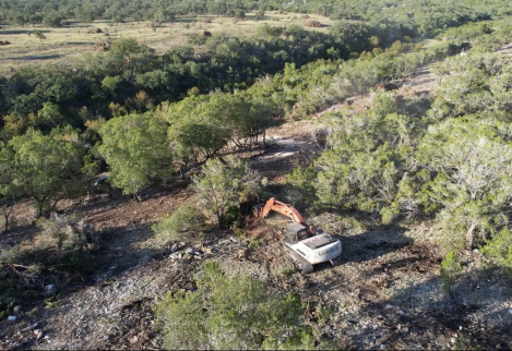 Using our excavator to open up a cedar monoculture.