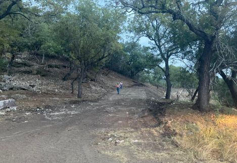 We helped this landowner create a new main entrance by carving out a road through thick cedar and a steep hillside.